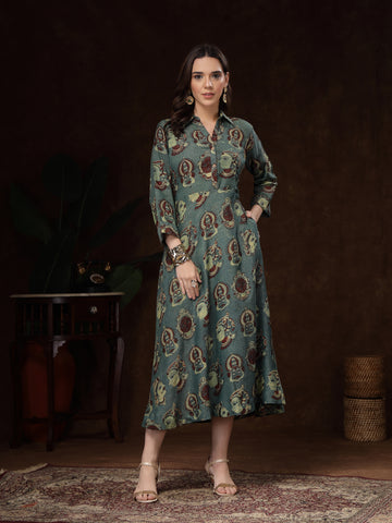 Woman wearing a patterned dress standing in a dark room with a textured floor.